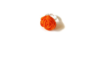 in a bright orange color a crocheted rose ring