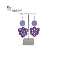 elegant lilac and purple earrings on a earrings stand display